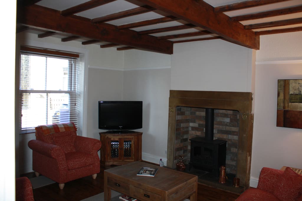 Relax in the cozy sitting room by the fireplace.
