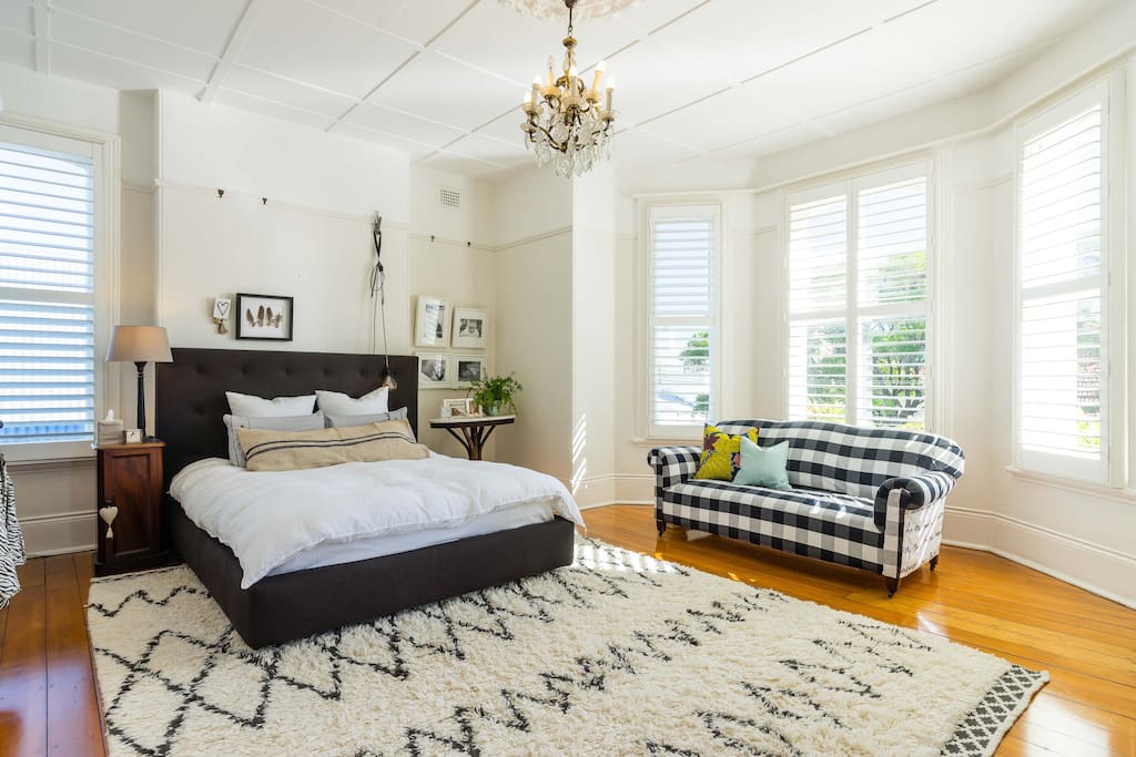 Large master bedroom with beautiful bay window and shutters