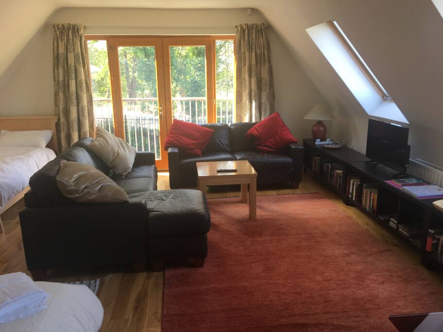 Seating and TV area, French style verandah overlooking the Ormiston Estate