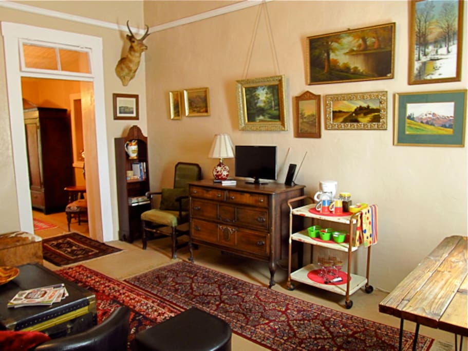 Here is another view of the front room. Coffee cart with everything for a fresh cup of coffee or tea. Wine glasses and opener as well.