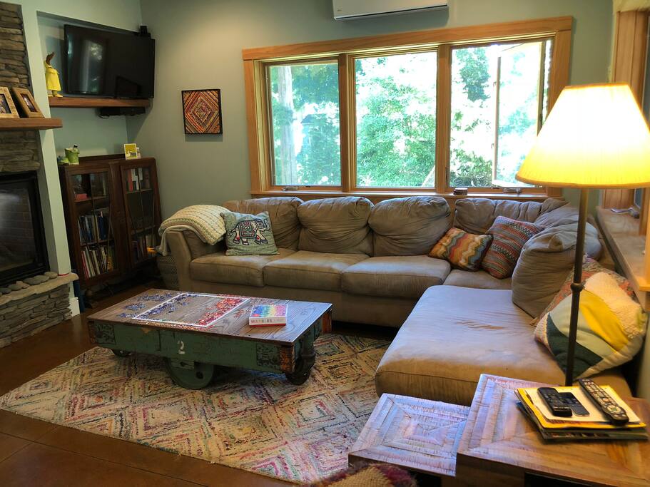 Bookshelves are stocked with books and cupboards are stocked with puzzles and games.