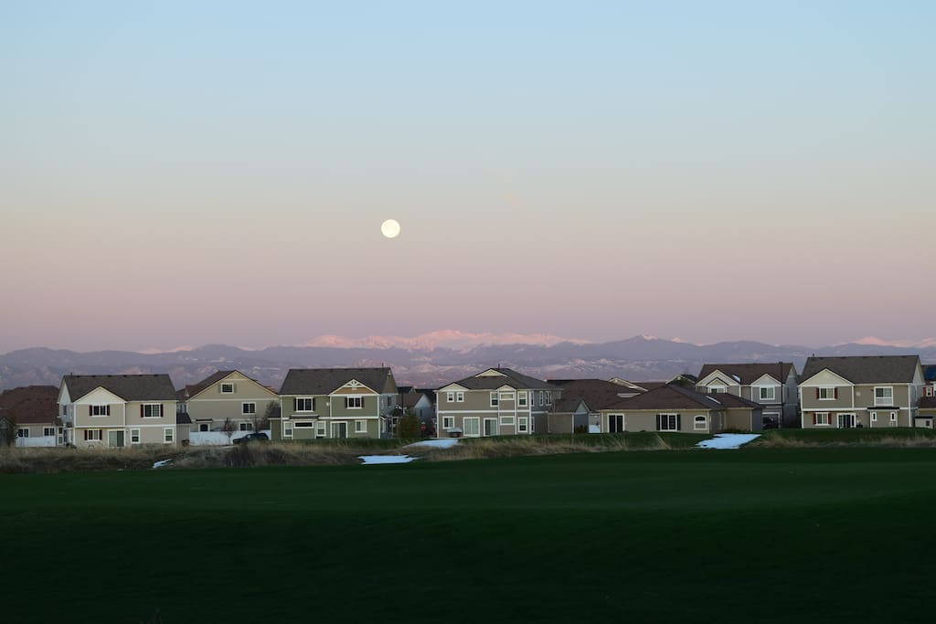 Sunrise with moon over the mountains