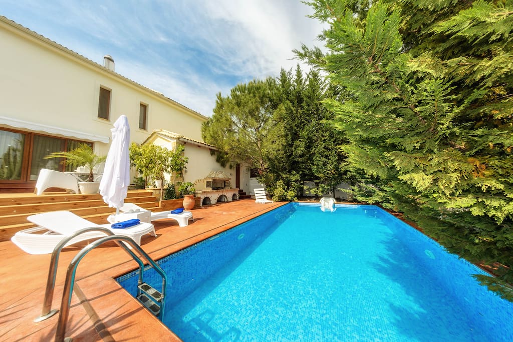 Swimming pool area with sunbeds, umbrellas & outdoor BBQ facilities