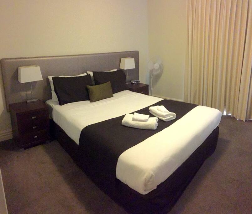 Comfortable Queen bedroom with access to outside balcony area. Light with good airflow.