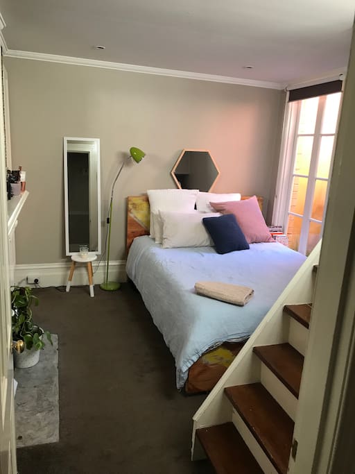 Bedroom 2: Large room with an upstairs loft/study retreat. High ceilings, beautiful atrium provides natural light all day. Queen Bed