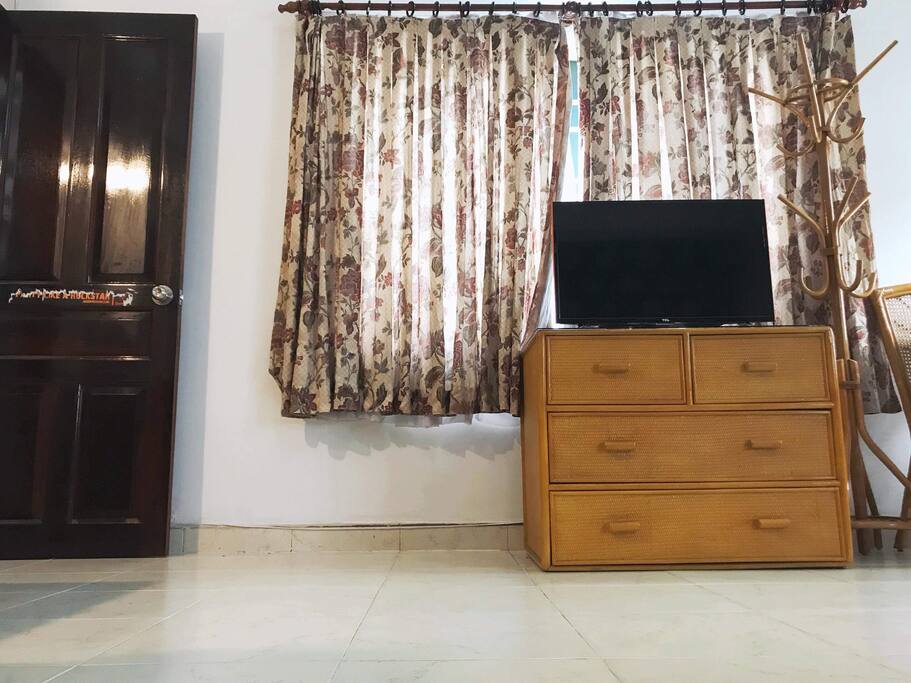 Walking into the room, on your left side is a TV placed right in front of your bed