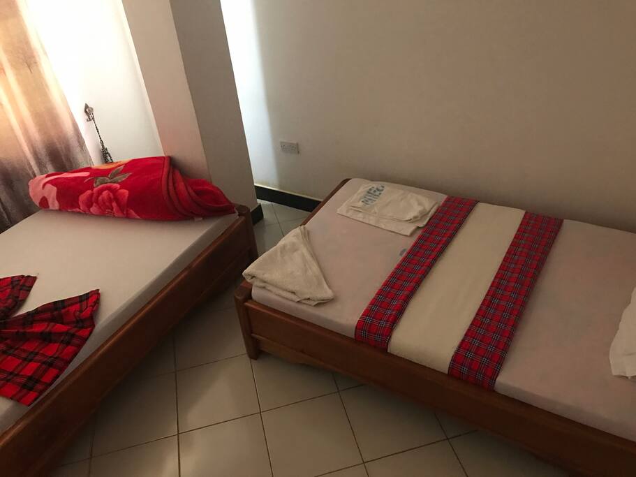 Twin room decorated with local masai clothing and nice local wall drawings art.