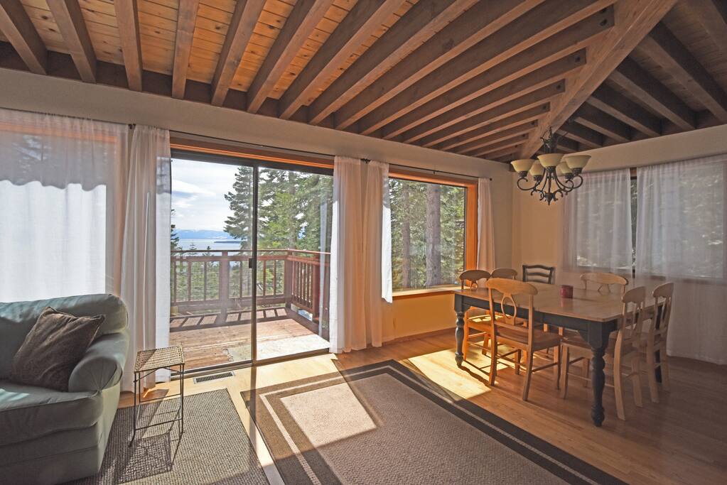Bright dining room with natural sunlight a wall of windows