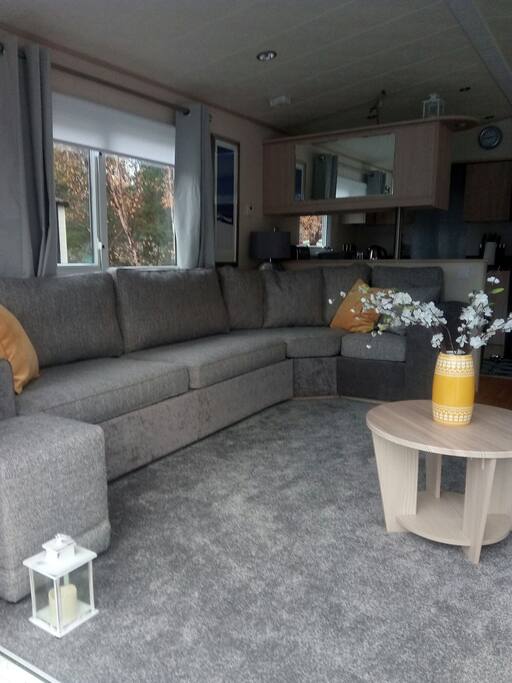Living area with brand new sofa, with sofa bed and brand new carpet
