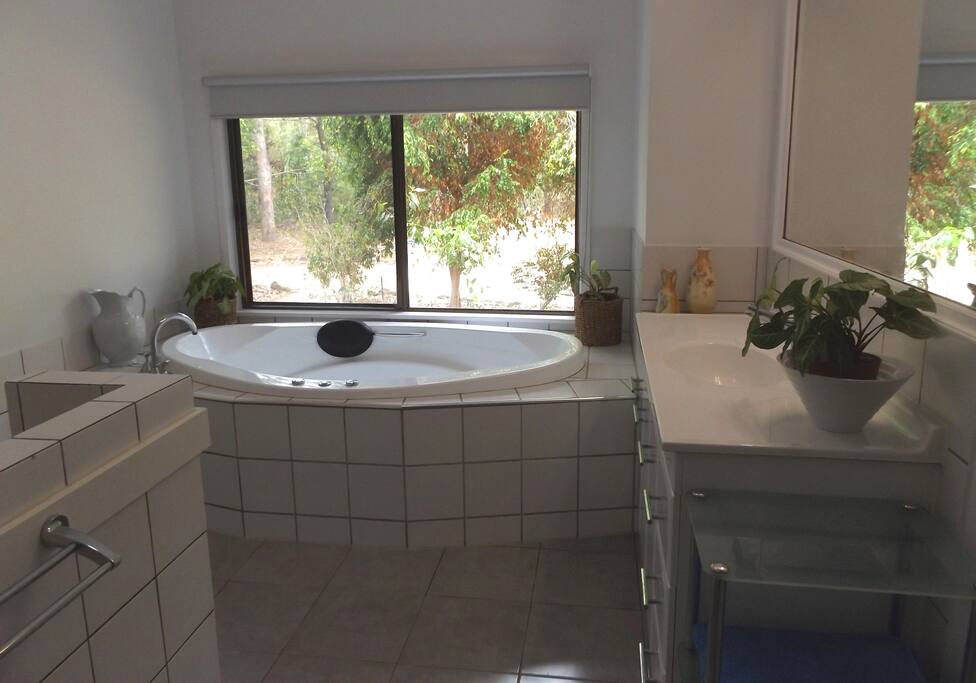 Bathroom with spa and no see through roller blind.