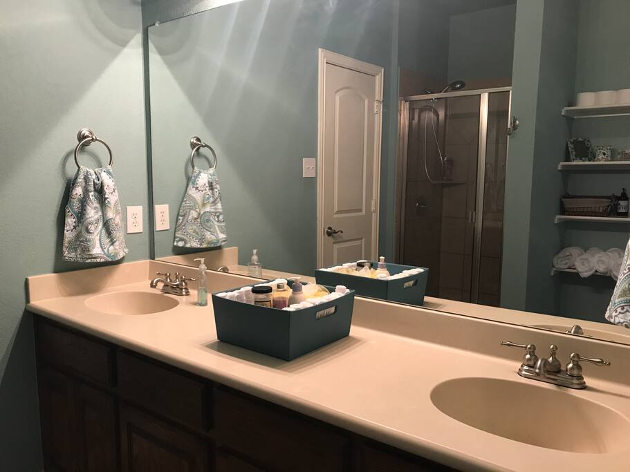 Private bathroom with tub and shower attached to bedroom