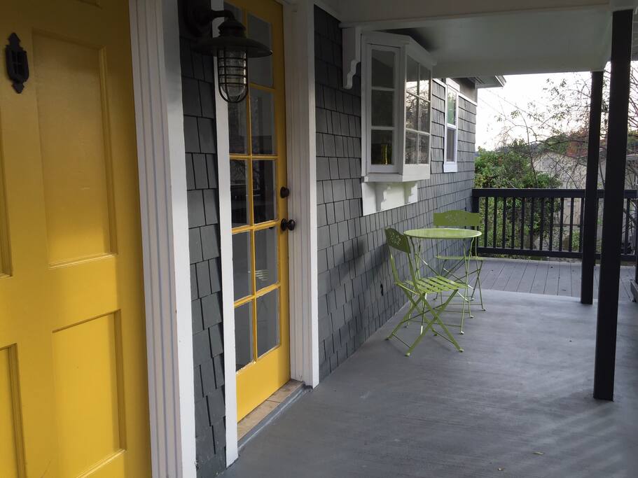 deck with bistro table, front door and kitchen door