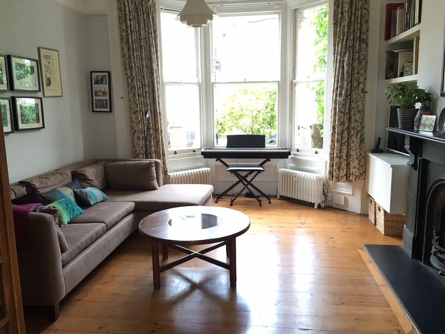 Front sitting room with digital piano and smart TV