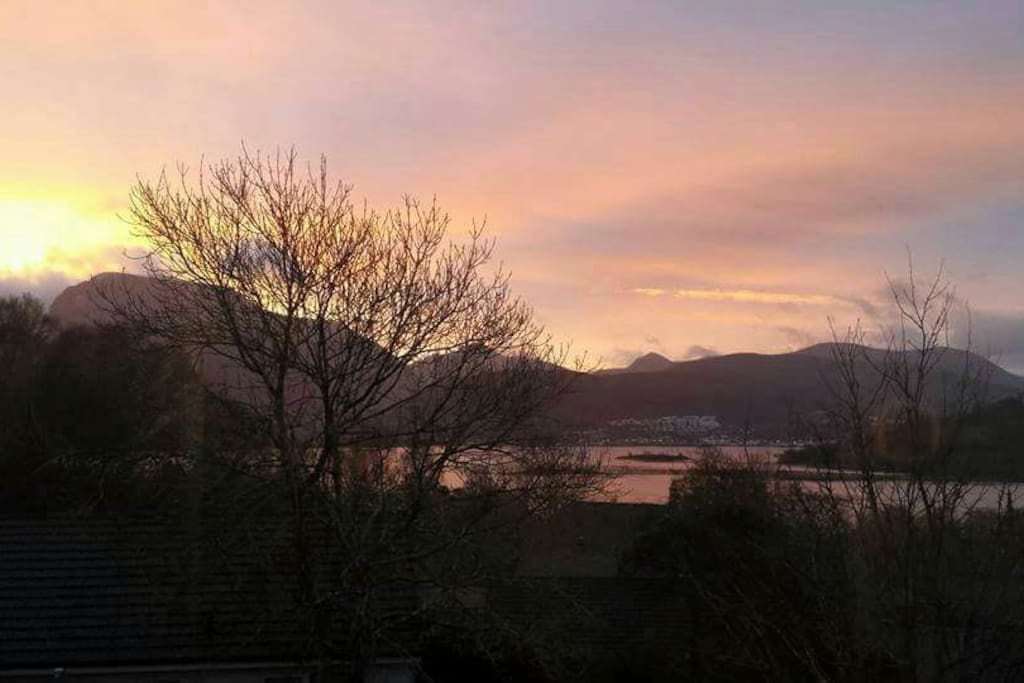 The mountain on the left side is the view of Ben Nevis at sunrise . My house is south facing and also with loch views towards Fort William