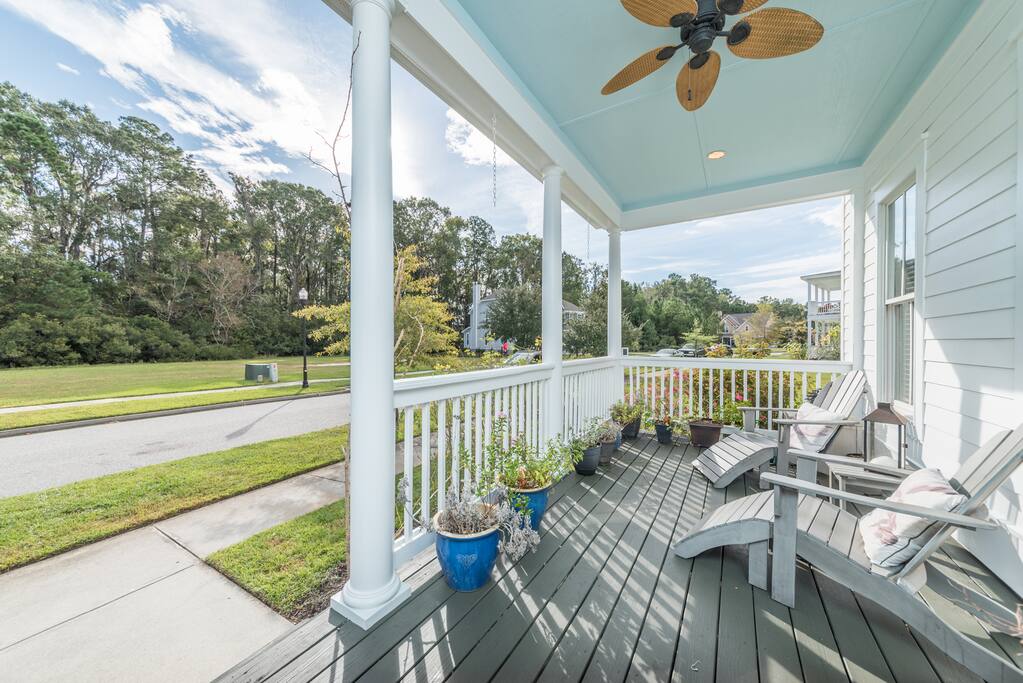 Gorgeous wrap around porch big complete with table for 8 and quiet reflecting area, southern fans
