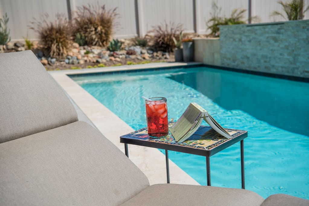 Relax poolside with a book and drink