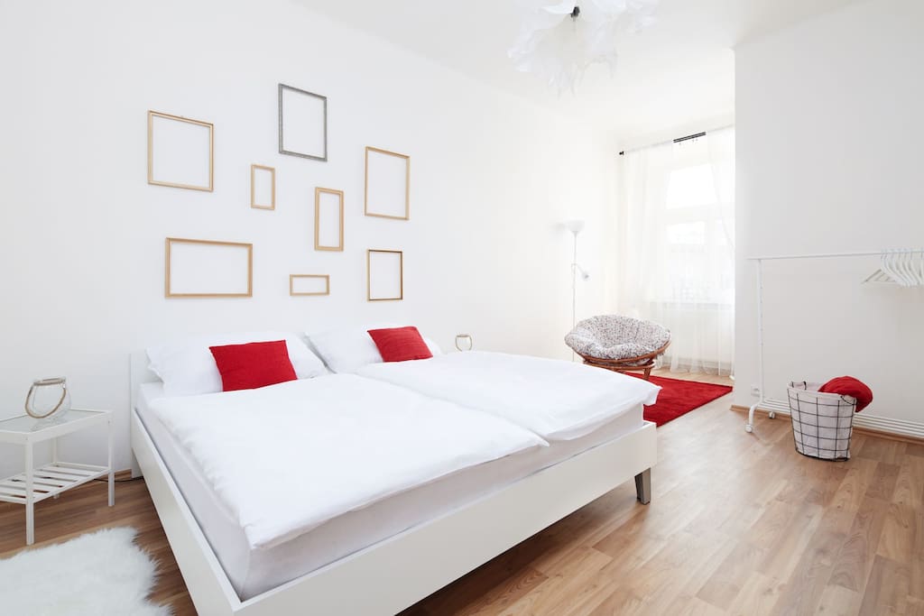 The apartment consists of two bedrooms; this one is delicately decorated with golden frames. Together with red patches here and there, this creates very warm and pleasant atmosphere.