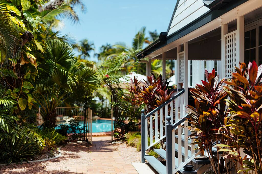 Lush tropical garden with pool and butterflies