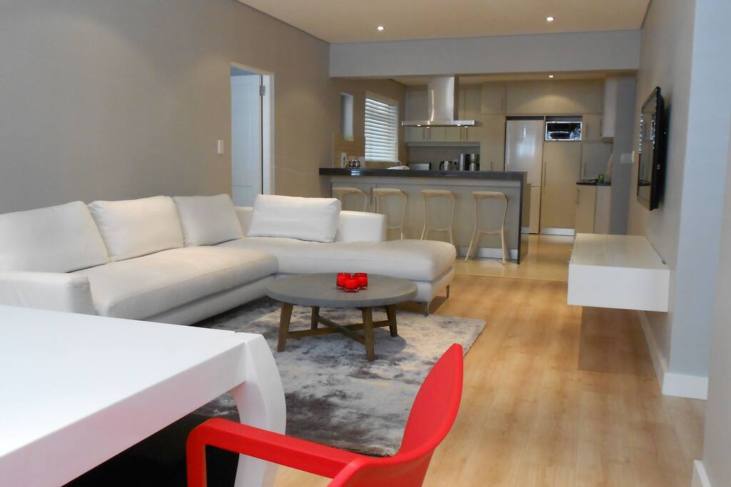 open plan lounge and kitchen - dining table with window seat that has view on the promenade