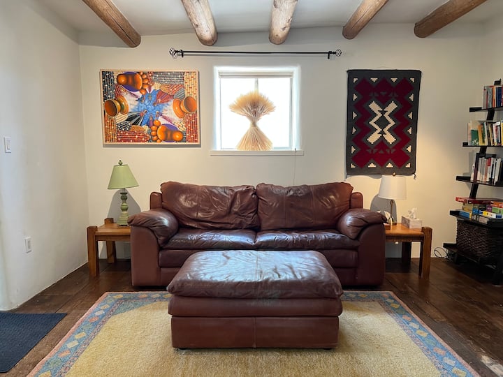 Living Room with leather couch, TV with streaming capacity, DVD player, and Bluetooth stereo system. Books, games, puzzles too!