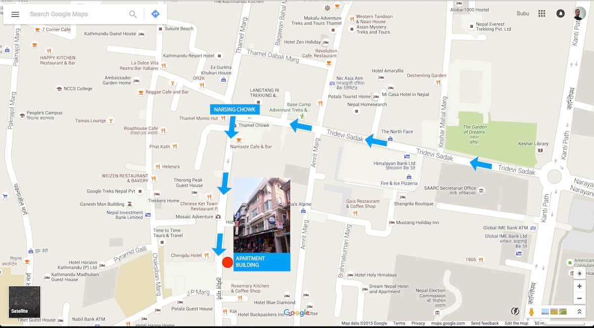 The map illustrates the surrounding area of the apartment, highlighting nearby streets and attractions in Thamel. Clear arrows direct towards the apartment building, emphasizing its convenient location within a vibrant tourist hub full of shops and restaurants.