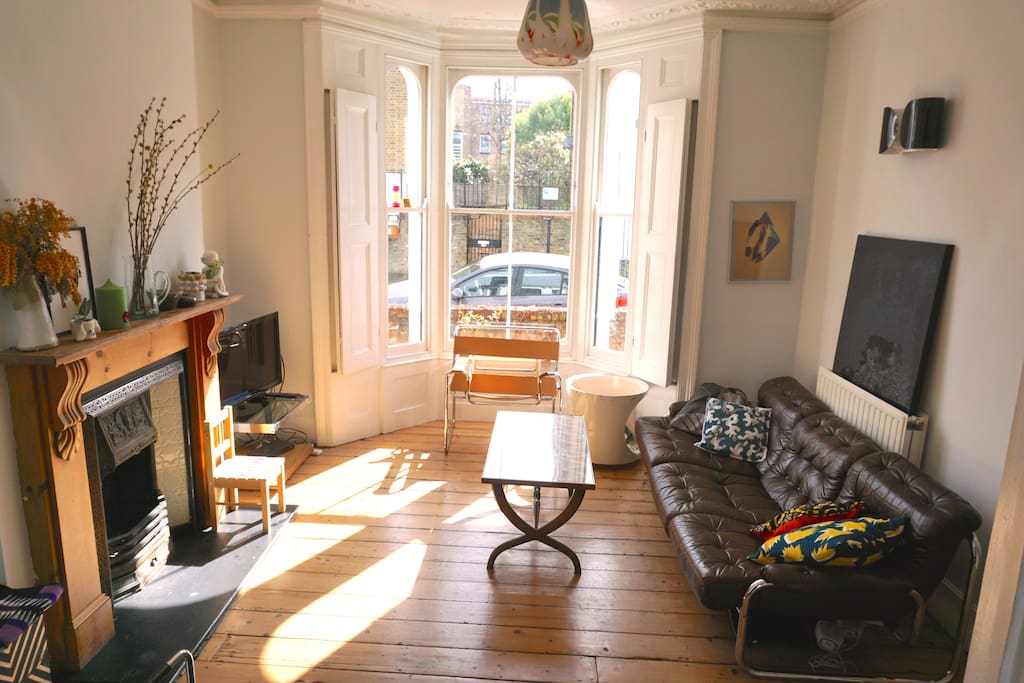 large 2 room sunny lounge with working fireplace and original shutters