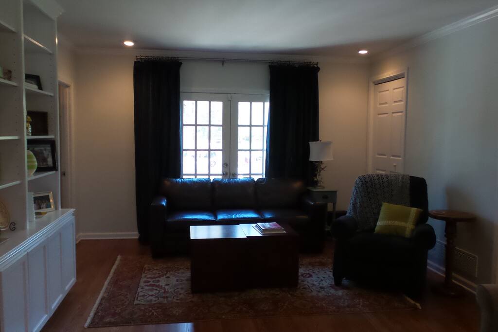 Large den - showing recliner and leather sofa bed.