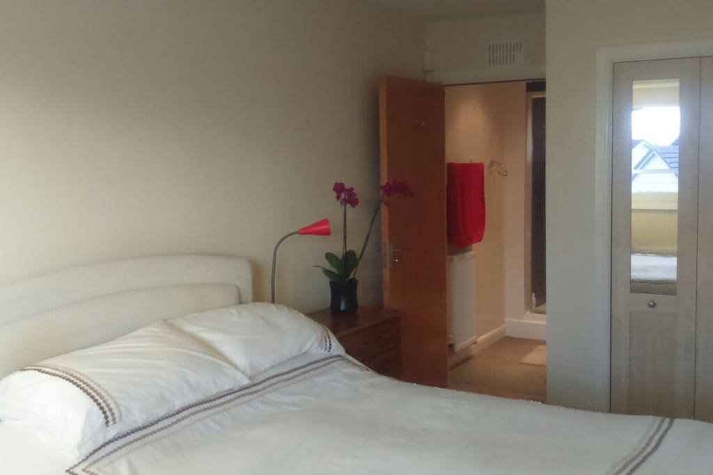 Master bedroom with ensuite bathroom behind