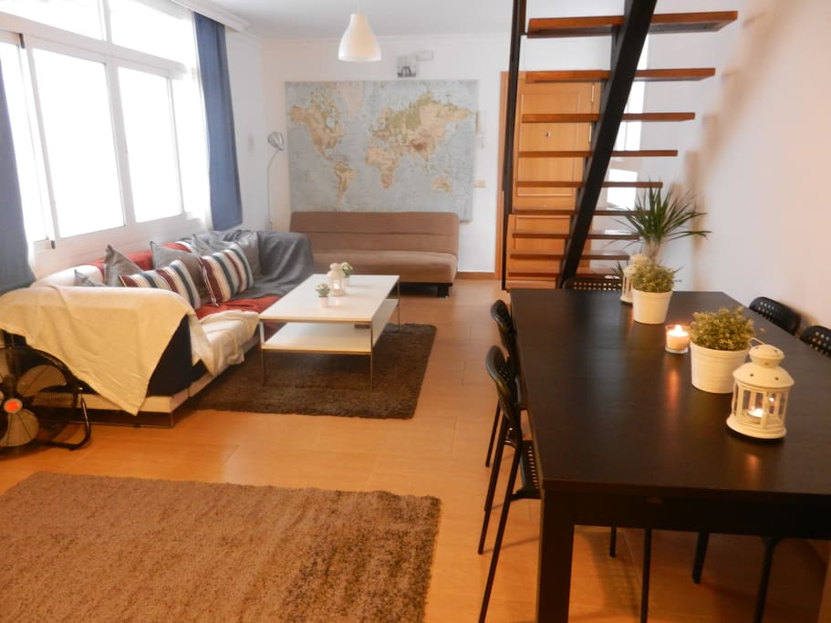 Living room with comfy sofas and large dining table that can be used as a workspace