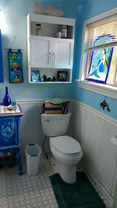 Ocean themed bathroom gives a vacation vibe.