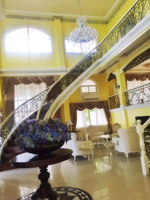 Living Area with Sweeping Staircase.