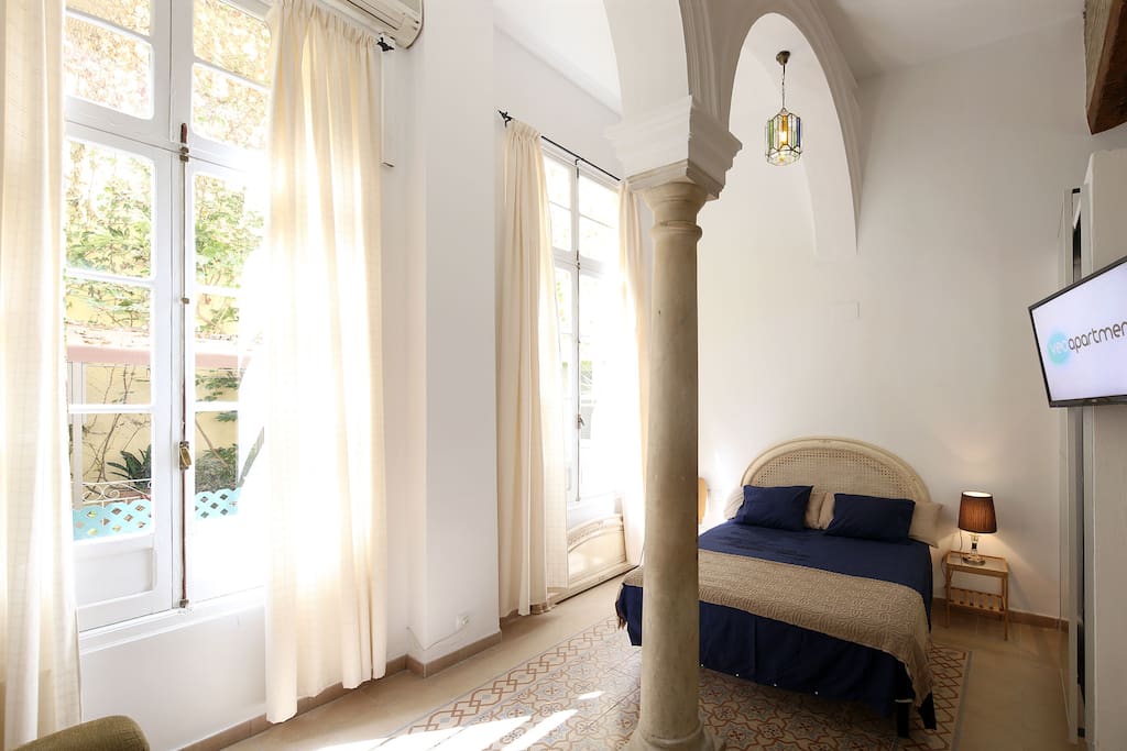 Bedroom with a double bed and TV.
