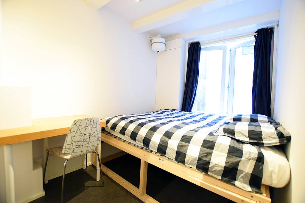 The first bedroom includes a comfortable bed and workingdesk