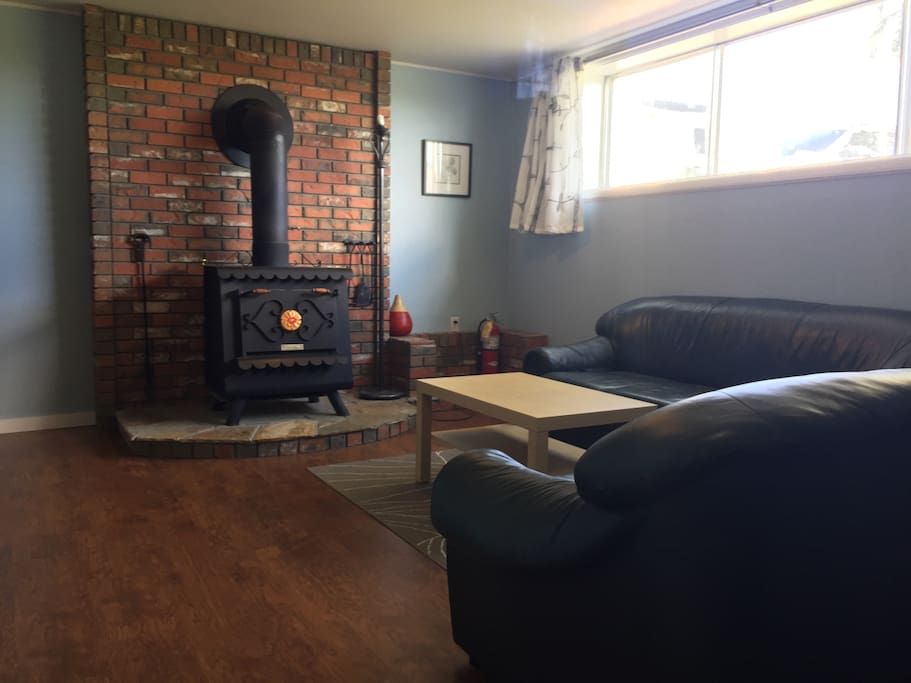 Living Room. The stove is for show. No fires inside in the summer. We do have a fire pit outside.