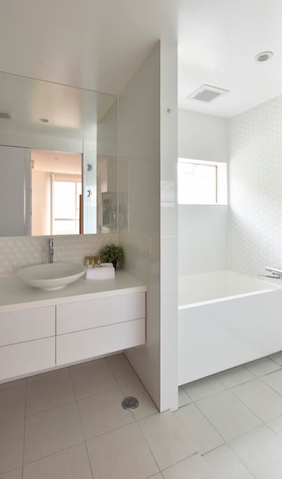 Custom tiled bathroom with garden view.