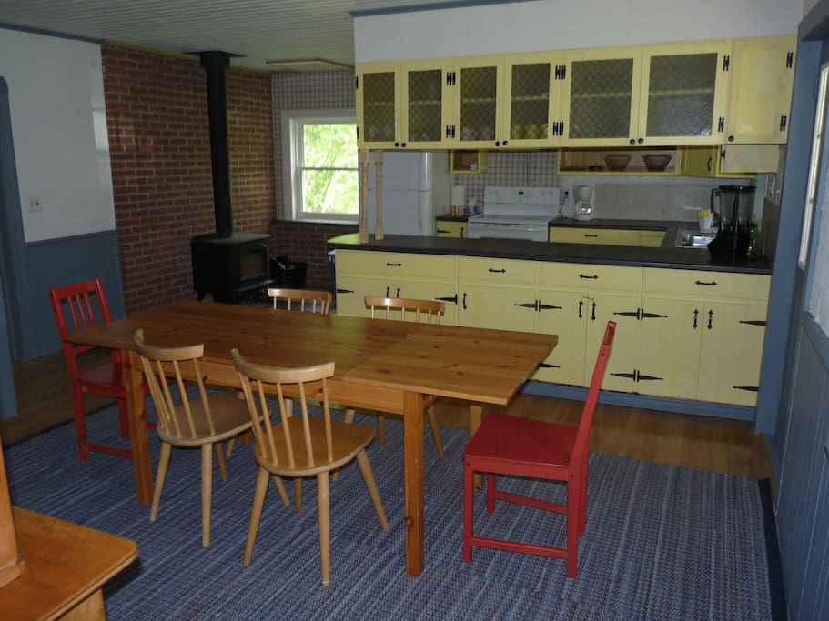 Dining room and kitchen -- fully stocked with plates, cutlery, pots, pans, bowls, tools etc.