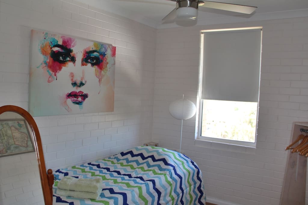 Spacious room for single guests, with full length mirror & clothes rack with hangers.