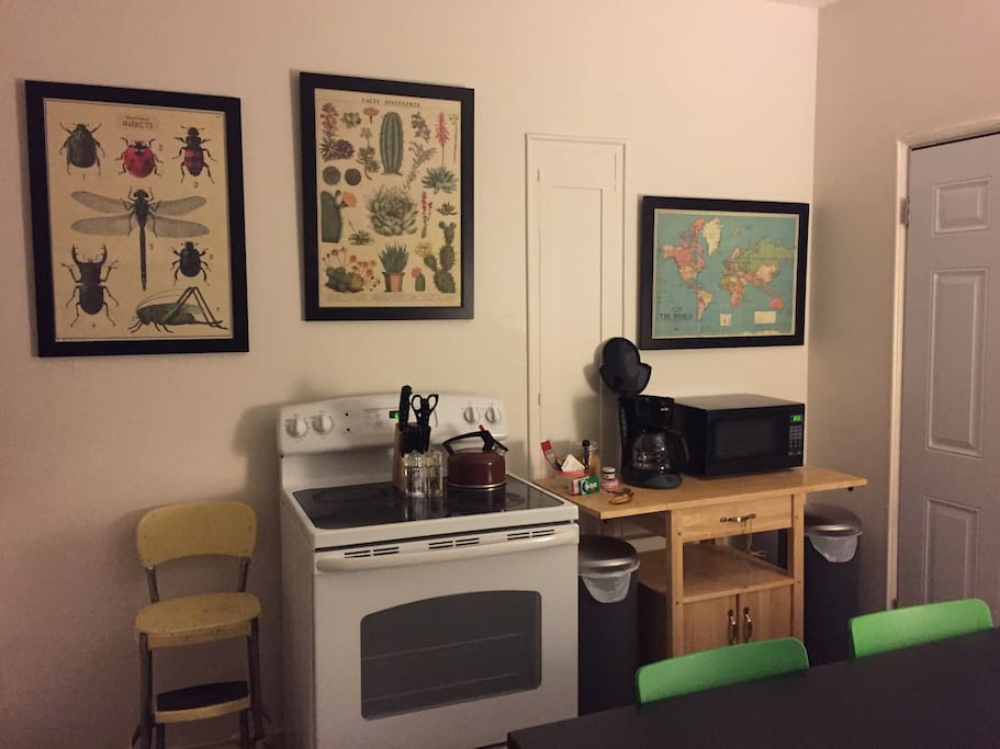 Kitchen/stove/microwave/coffee pot/coffee/creamer/sugar/tea/honey/backdoor with screen gate/giant kitchen table/3 chairs/ toaster/fridge