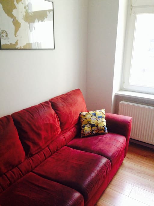A cozy sofa in the kitchen. Perfect for a nap.