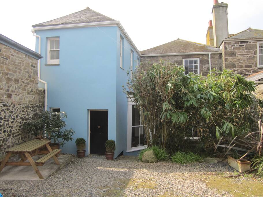 Rear of house with double gated off road parking for two vehicles and a delightful walled garden.