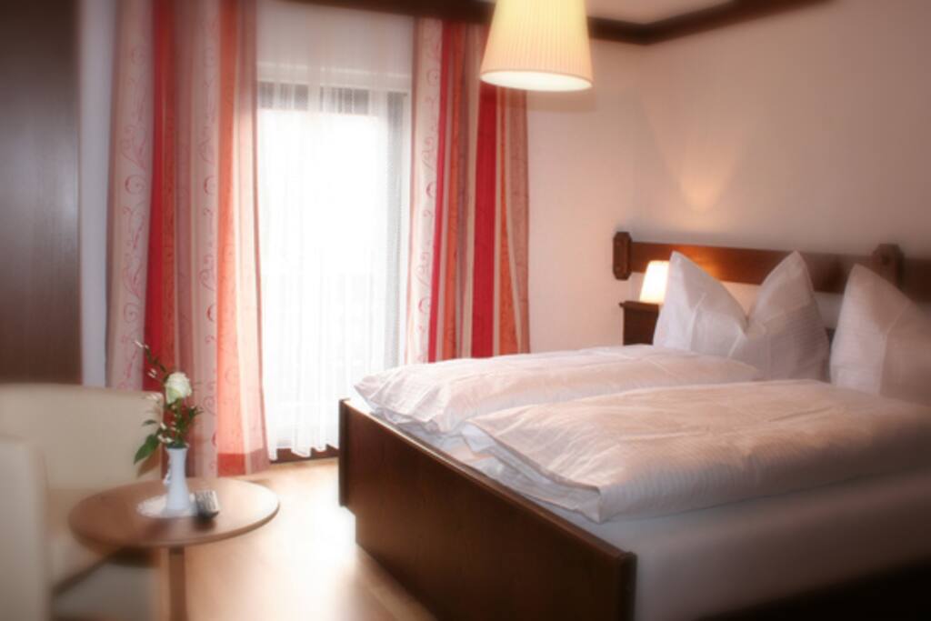 a room with double bed in the family room