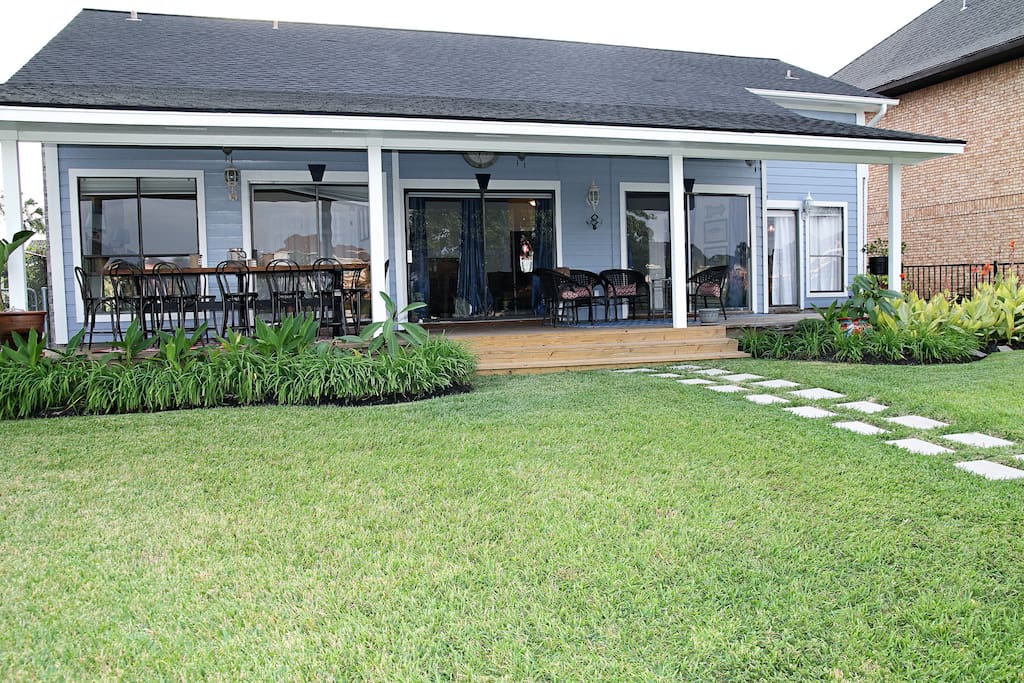 Under the covered patio is a long, counter height table and an additional seating area.