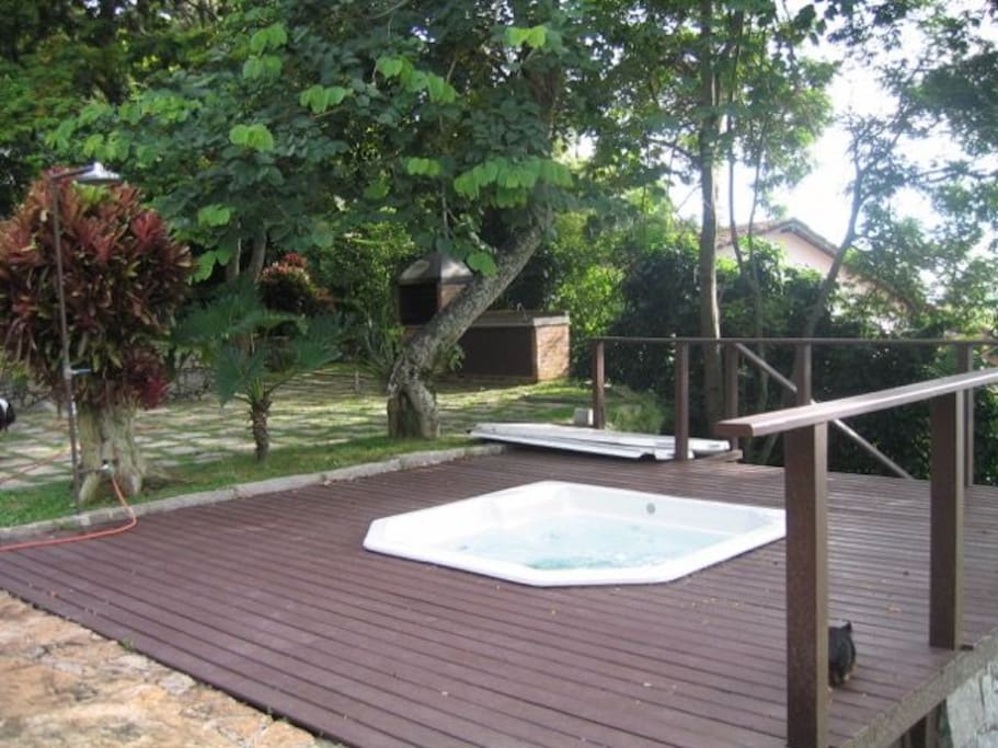 jacuzzi, deck, bar-b-que, small section of gardens