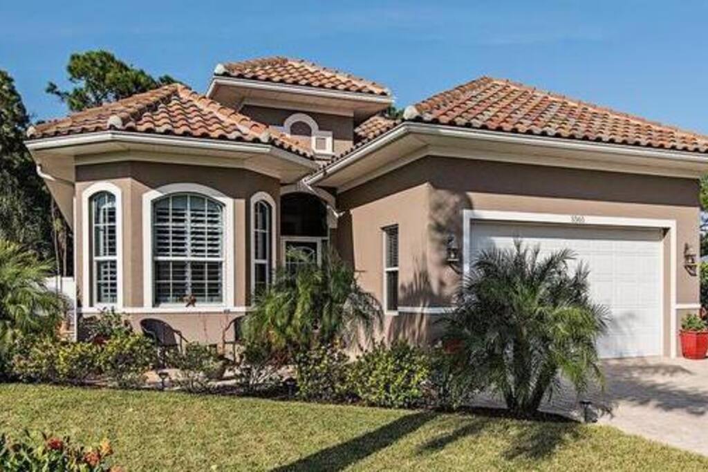 2 car garage and sitting area in front of the house