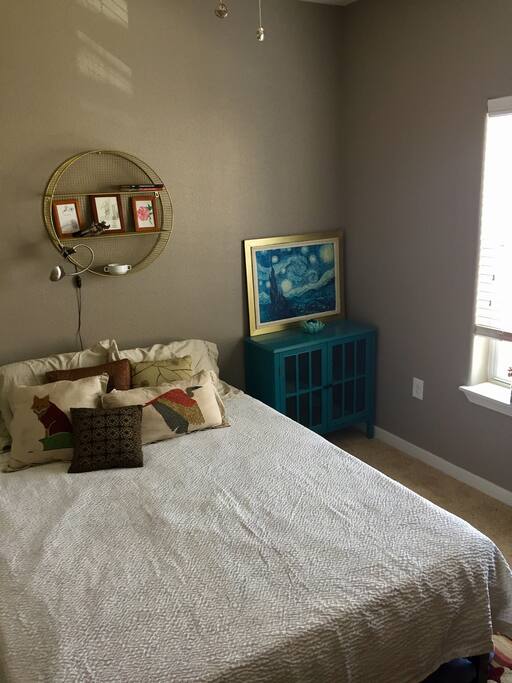Reading light and a small dresser cabinet within arms reach
