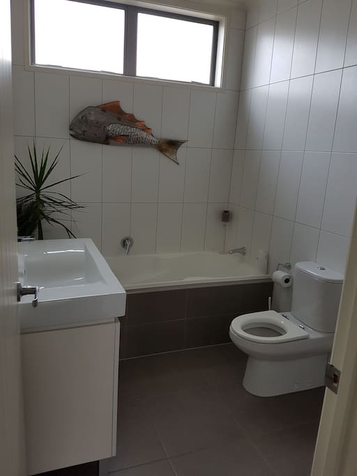 The private bathroom for guests. Has a bath and shower.