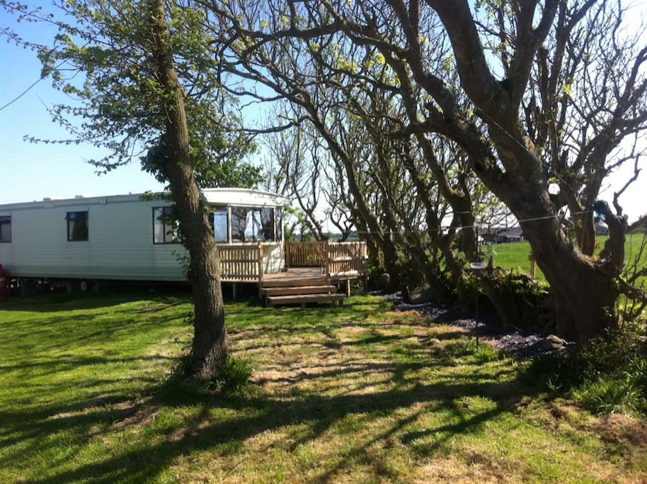The caravan nestled under trees