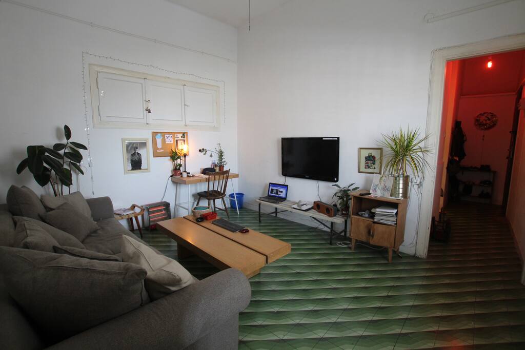 warm living room, with a tv and a writing table
