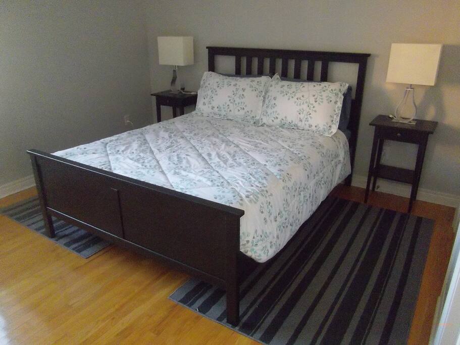 Queen bed in master bedroom with attached bathroom.
