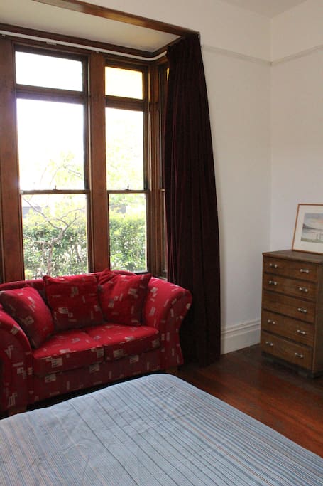 Your room also has a comfy two-seater couch and antique bedroom furniture.